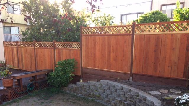 Cedar fence using post protector barrier system